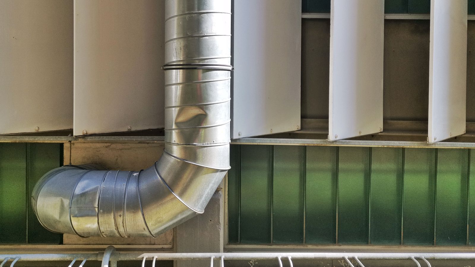 Workshop with heat exchange equipment, insulated piping, and a whiteboard showing thermal flow diagrams